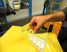 Image of person applying a Manifest Label